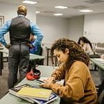 Student Cheating Behind Her Teacher During an Exam