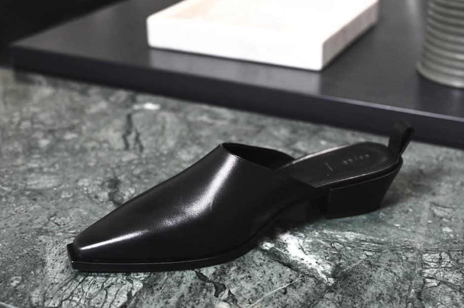 Stylish shiny shoe on marble surface