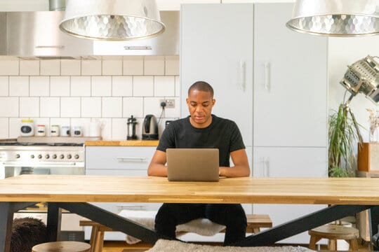 The Perfect Comfort and Safety in a Steel Toe Work Boot 2 UK, London, Man using laptop at kitchen table